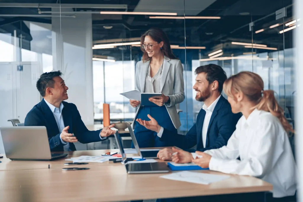 Corporate team discussing a group relocation plan during an office meeting.