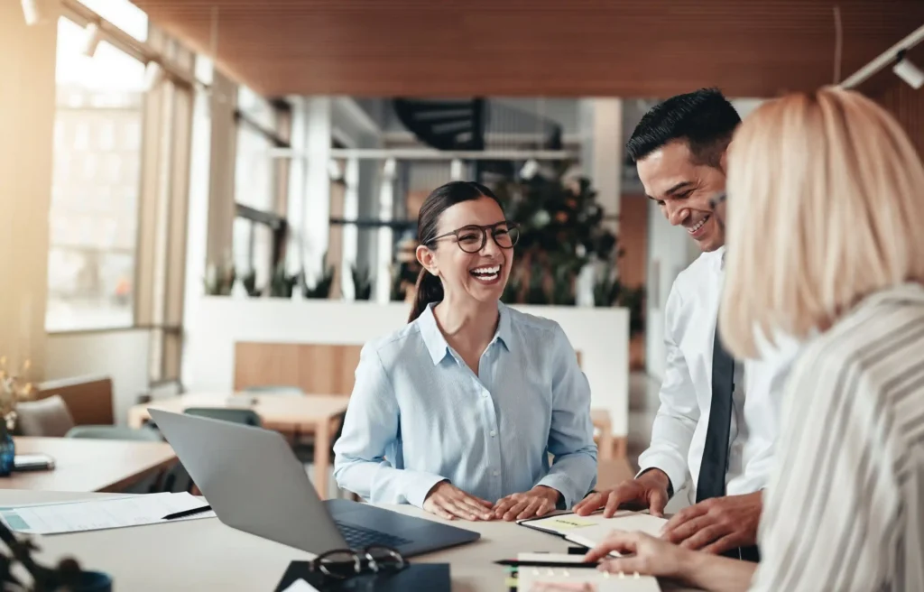 Employees discussing an internal transfer relocation in a modern office setting.