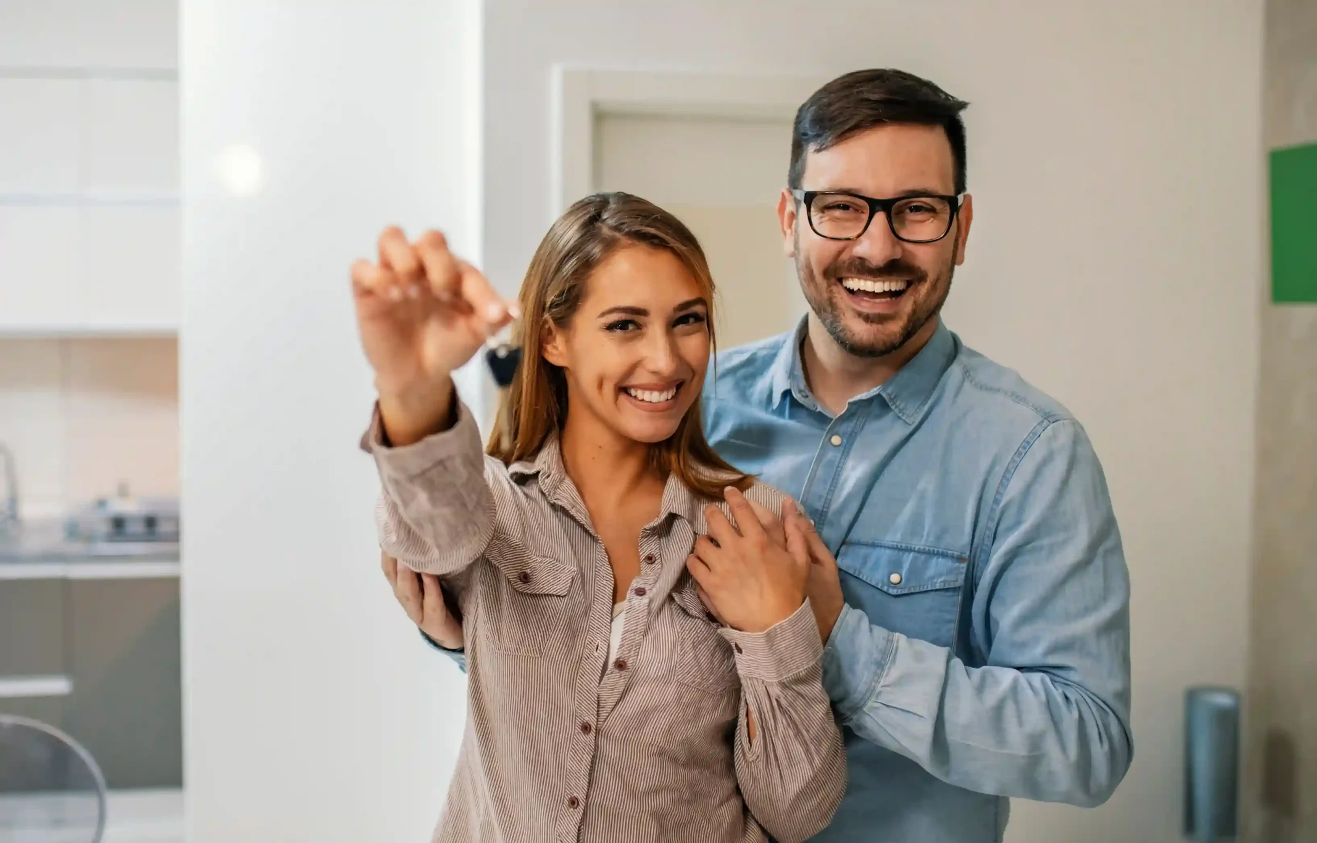 Happy couple viewing their new home after completing a relocation purchase decision.