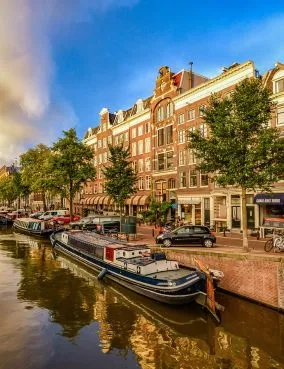 Houseboats moored along a scenic Amsterdam canal