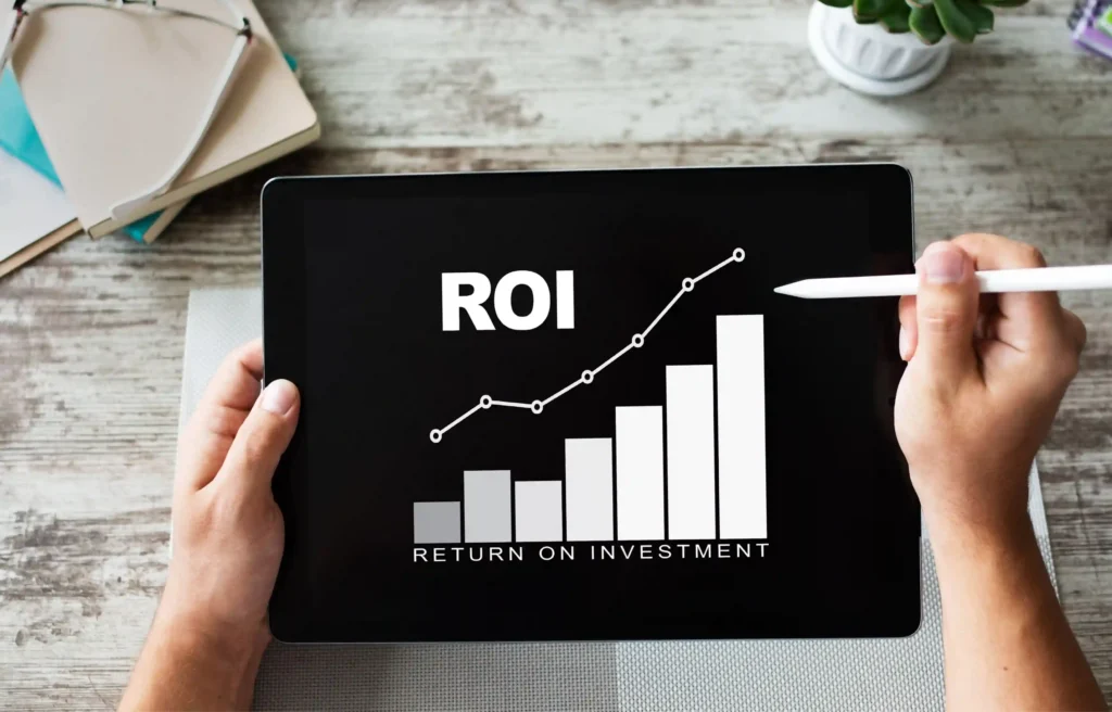 Tablet displaying a rising relocation ROI chart representing return on investment and business performance.