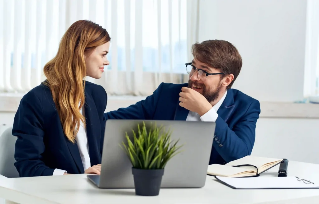 Two professionals discussing career plans during a dual career relocation meeting.