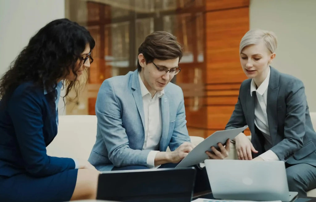 Business team reviewing relocation talent pipeline and hiring plans together in a modern office.