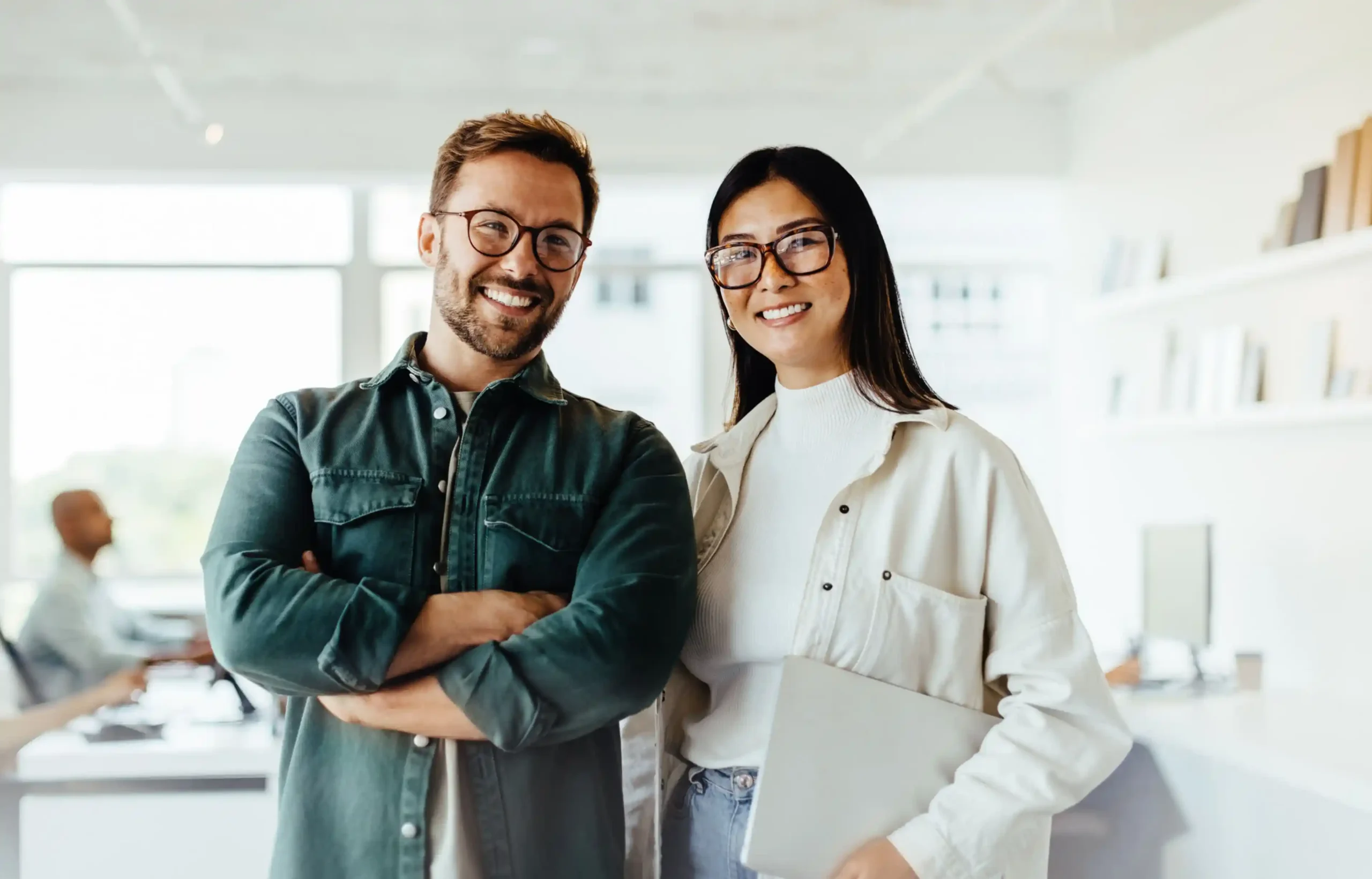 Two HR professionals in a modern office evaluating corporate relocation vendors to select the right employee relocation partner.