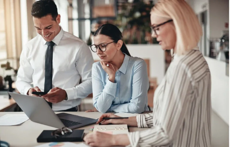 HR professionals reviewing relocation costs and employee mobility plans together.